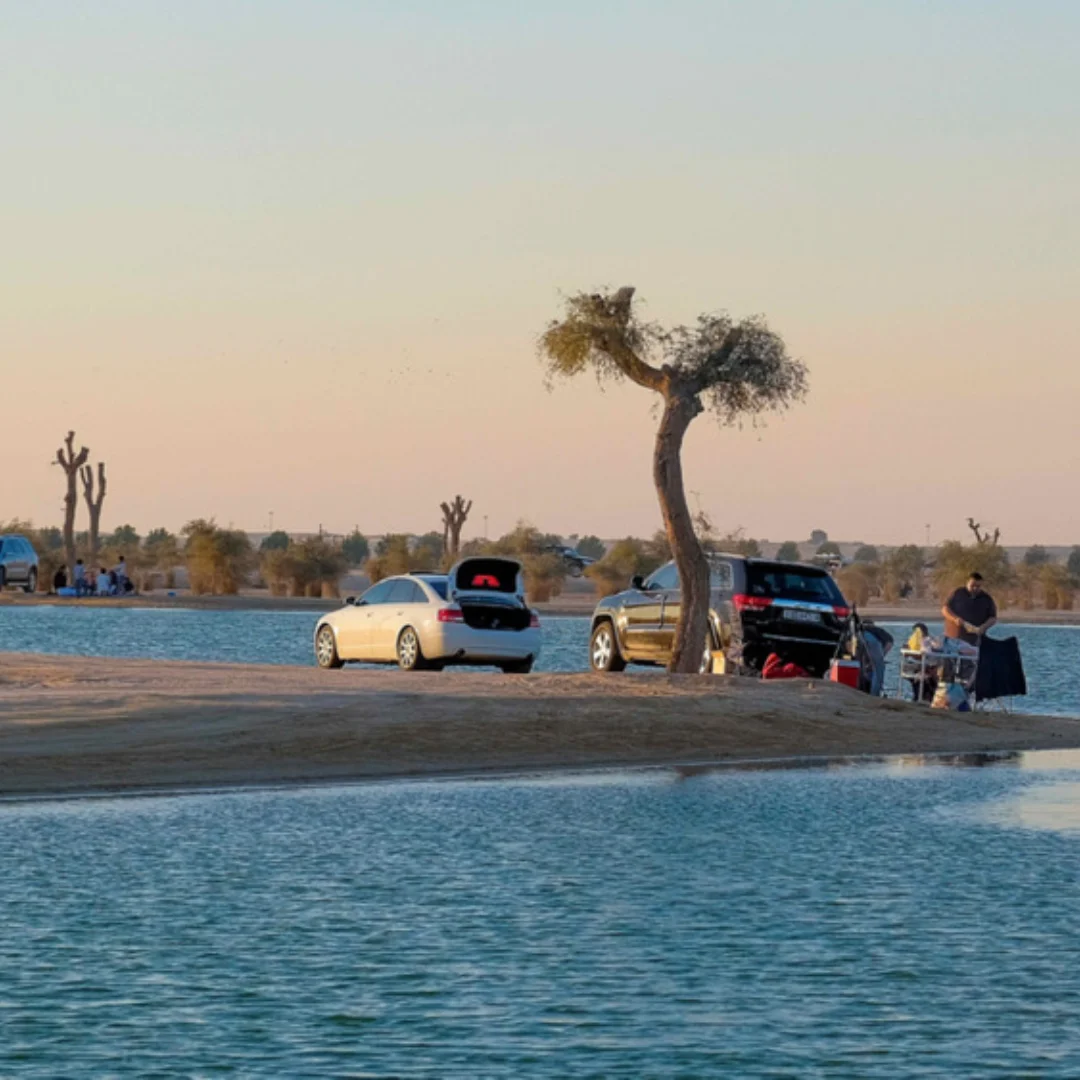 picture showing lake and people also car in al qudra area